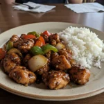 Black Pepper Chicken stir-fry served with rice and vegetables