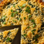 A golden-brown Spinach Parmesan Rice Bake fresh out of the oven, garnished with fresh parsley.