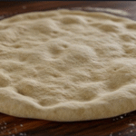 A rustic, bubbling sourdough pizza fresh out of the oven, with golden crust and melted cheese.