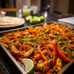 30-minute sheet pan chicken fajitas with colorful bell peppers and fresh lime garnish.