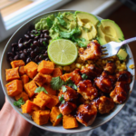 BBQ chicken sweet potato bowl with avocado, black beans, corn, and fresh lime.