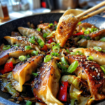 Pan of easy potsticker stir fry with vegetables and sesame seeds, lifted by chopsticks.