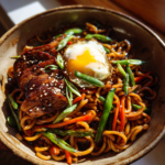 Easy 15-minute ramen noodle bowl with glazed meat, a fried egg, and fresh vegetables.
