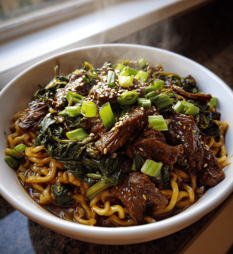 Savory slow cooker Korean beef noodles topped with fresh green onions and sesame seeds.