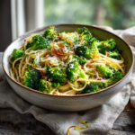Easy healthy broccoli pasta with parmesan cheese, caramelized onions, and red pepper flakes.